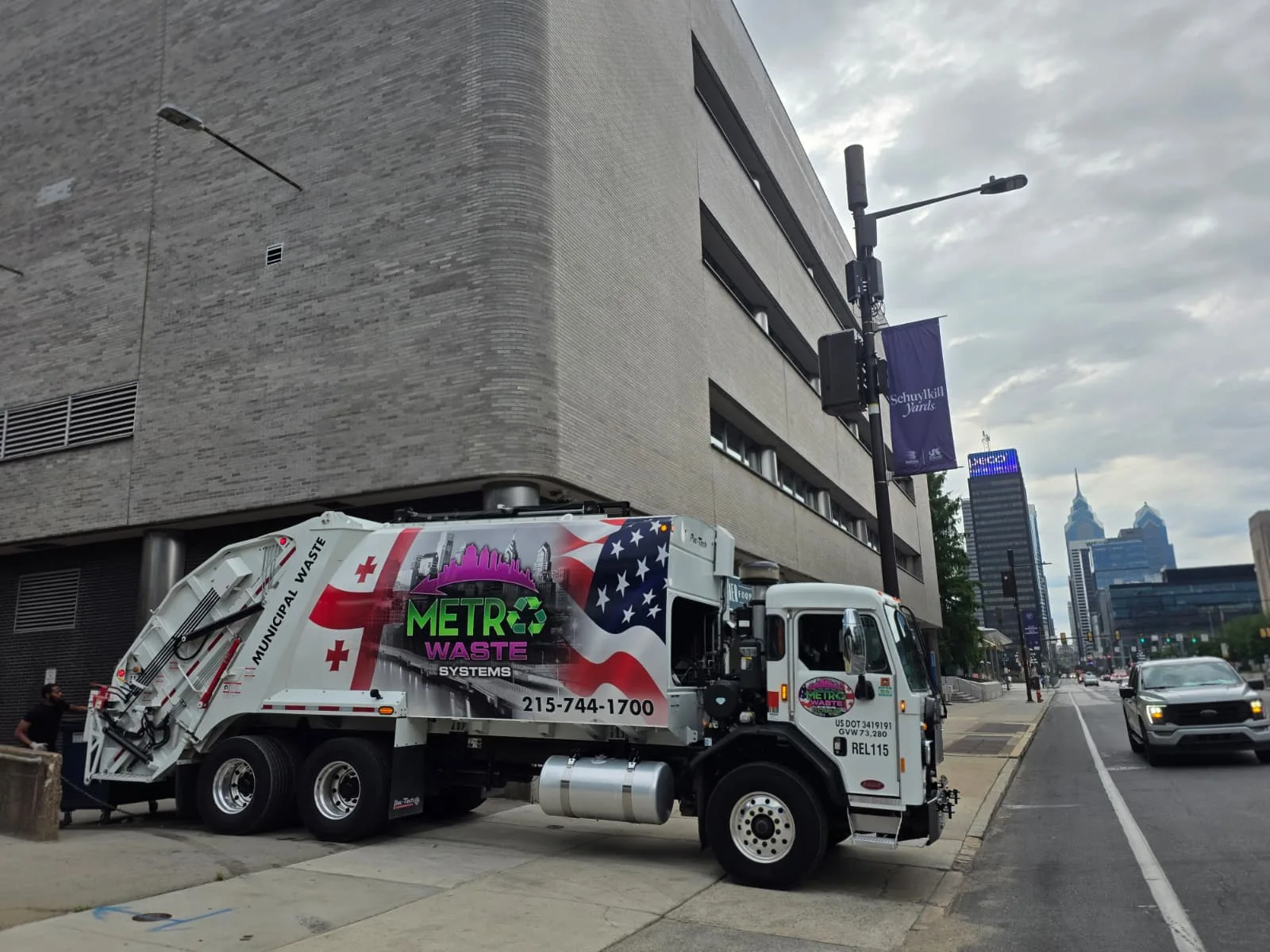 Commercial waste collection truck servicing a business