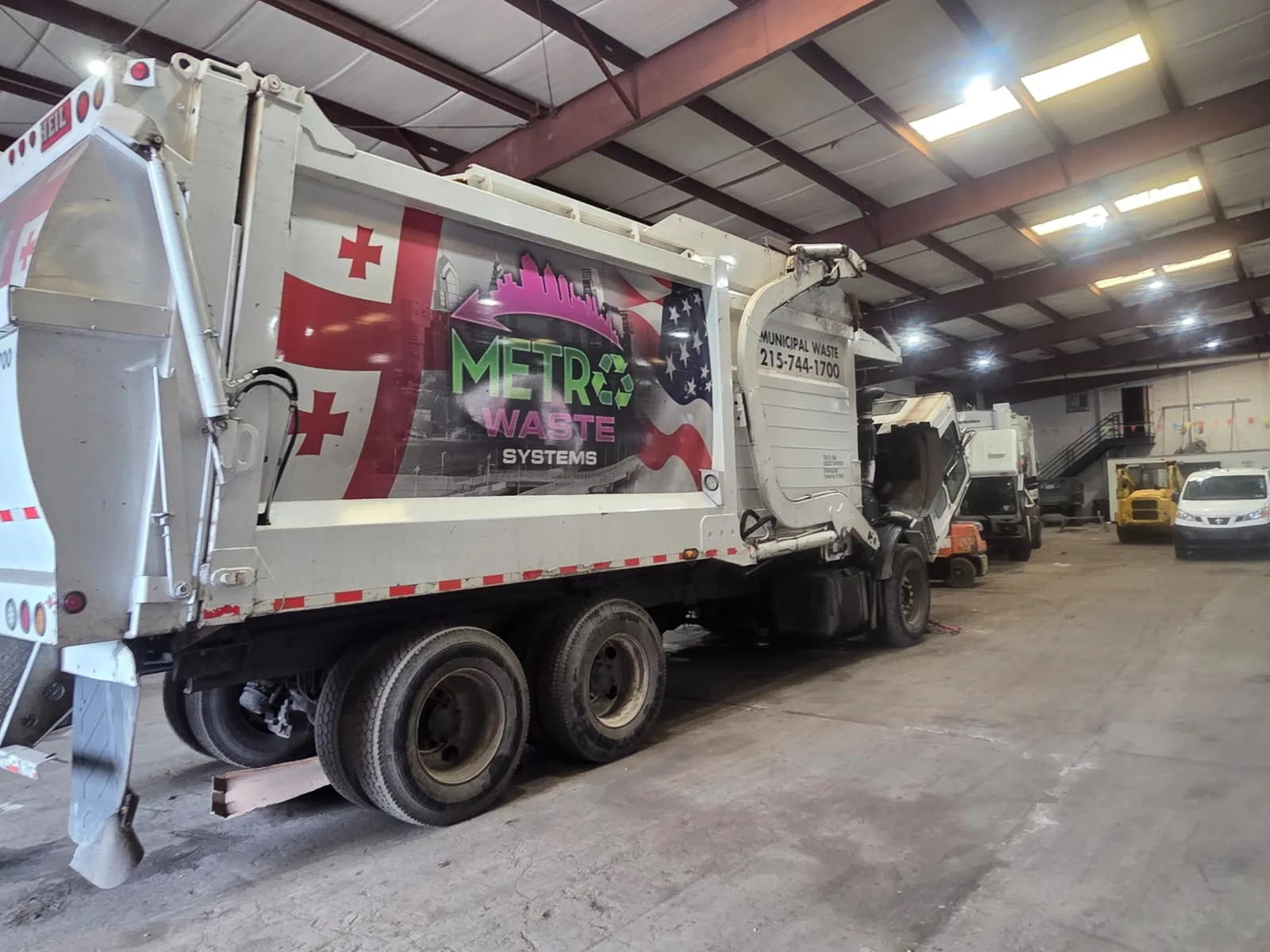 Front-load commercial dumpster service truck operated by Metro Waste Solutions in the Philadelphia area — image 5