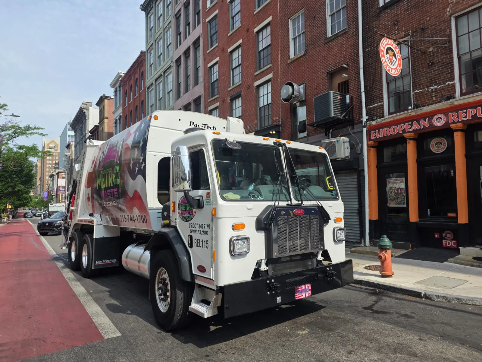 Rear-load collection truck on a city street