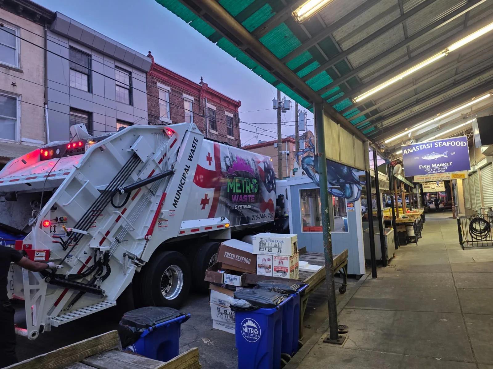 Rear-load commercial waste collection truck from Metro Waste Solutions on a Philadelphia metro route — photo 3