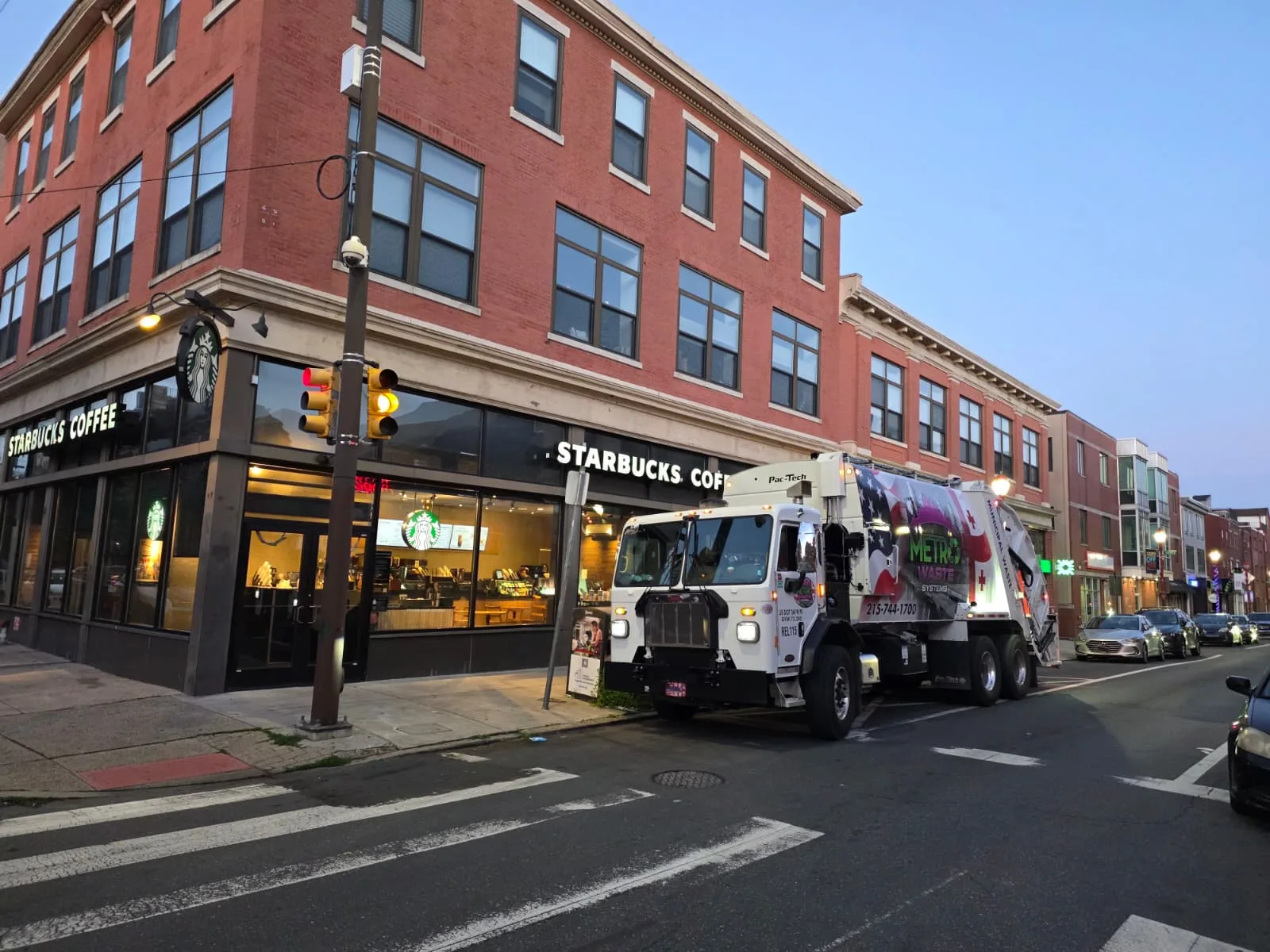 Rear-load commercial waste collection truck from Metro Waste Solutions on a Philadelphia metro route — photo 12